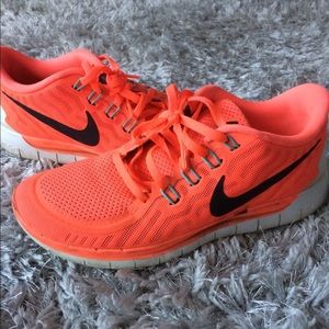 Neon orange Nike running shoe